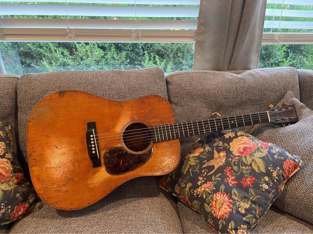 A 1941 D-18 guitar laying on a couch