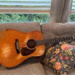 A 1941 D-18 guitar laying on a couch