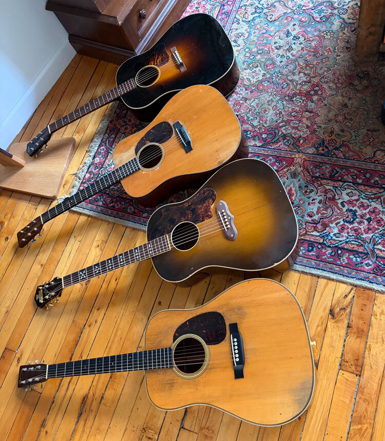 four vintage acoustic guitars in a row